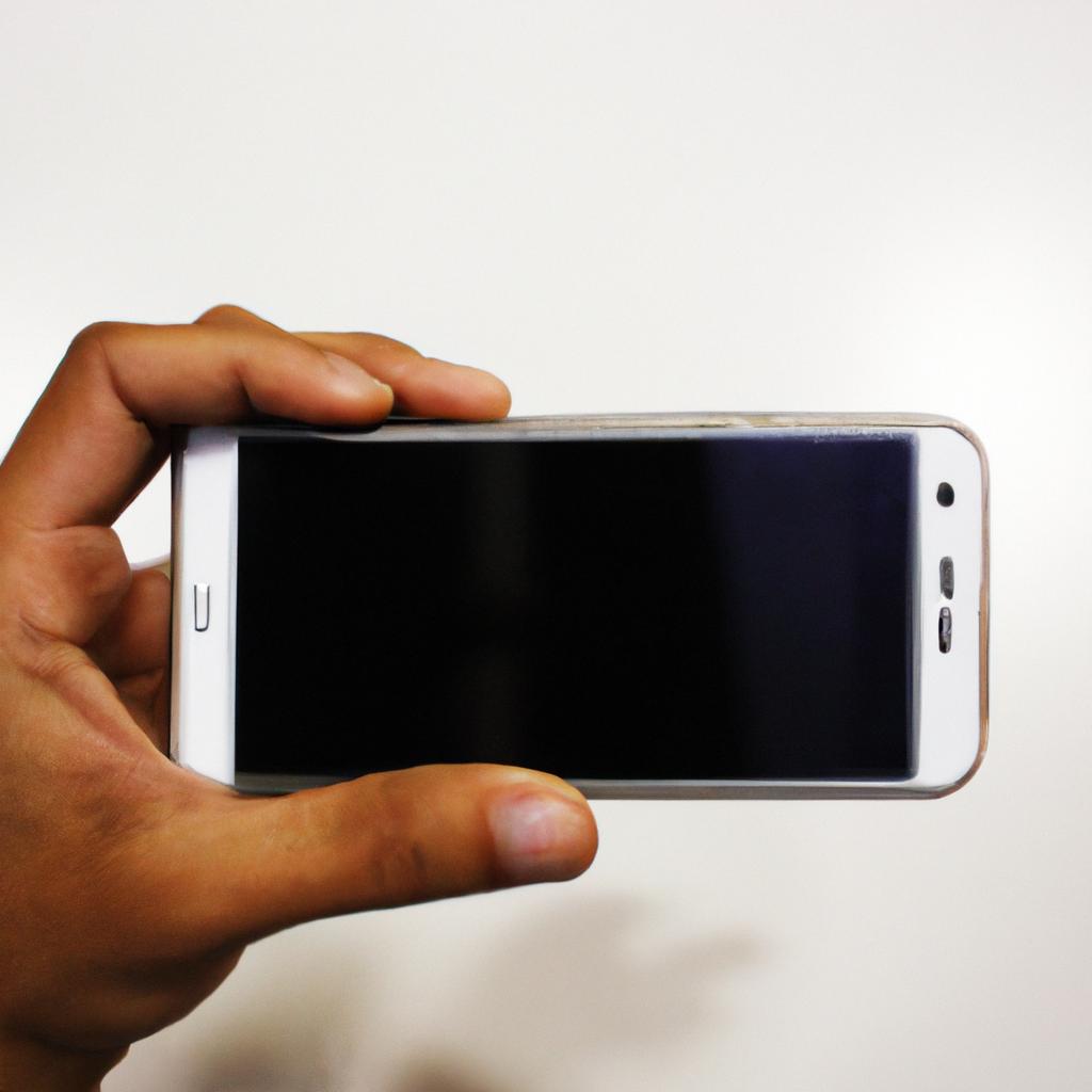 Person holding smartphone, connecting devices